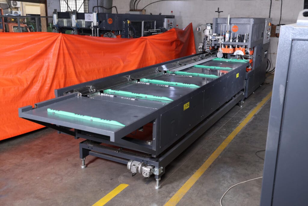 Industrial pipe extrusion downstream machine by Sica India in a factory setting.