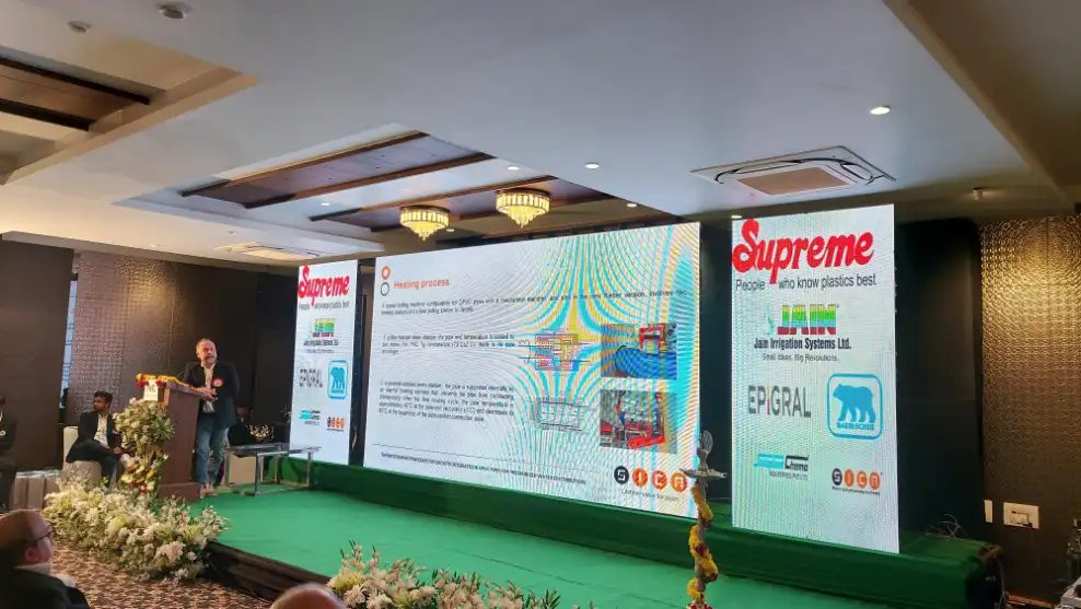 Speaker presenting at Supreme event on stage.