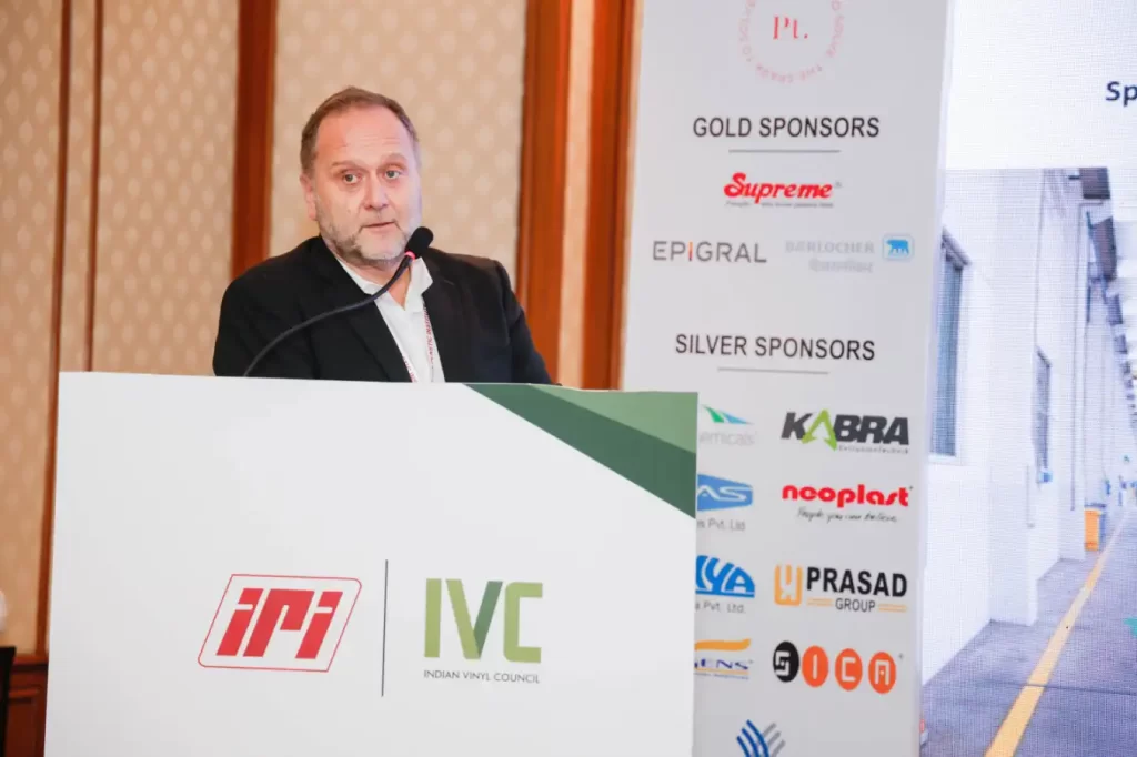 Speaker at Indian Vinyl Council conference podium.