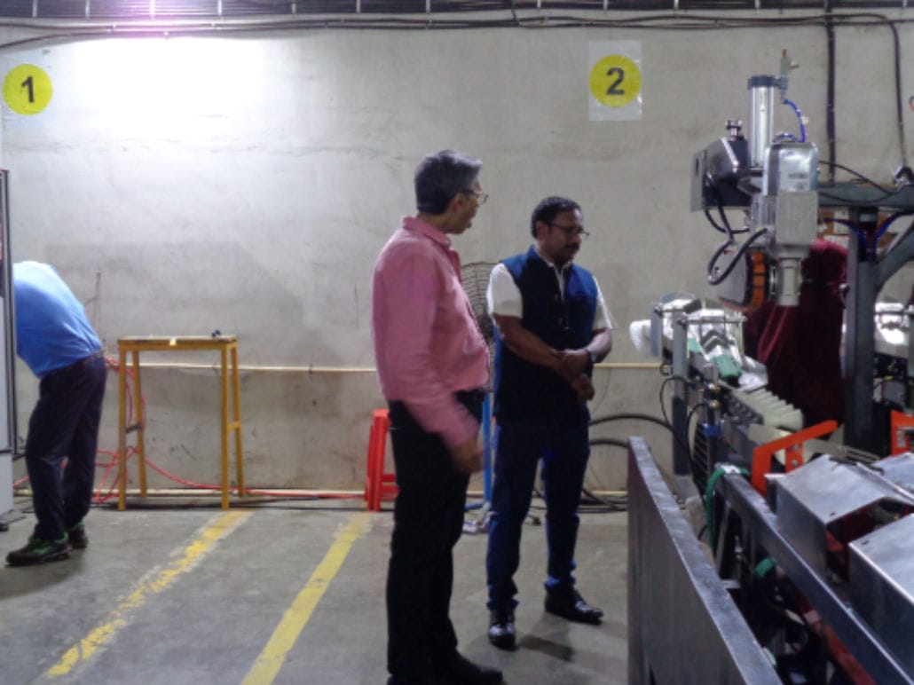 Manufacturing facility with workers and machinery.