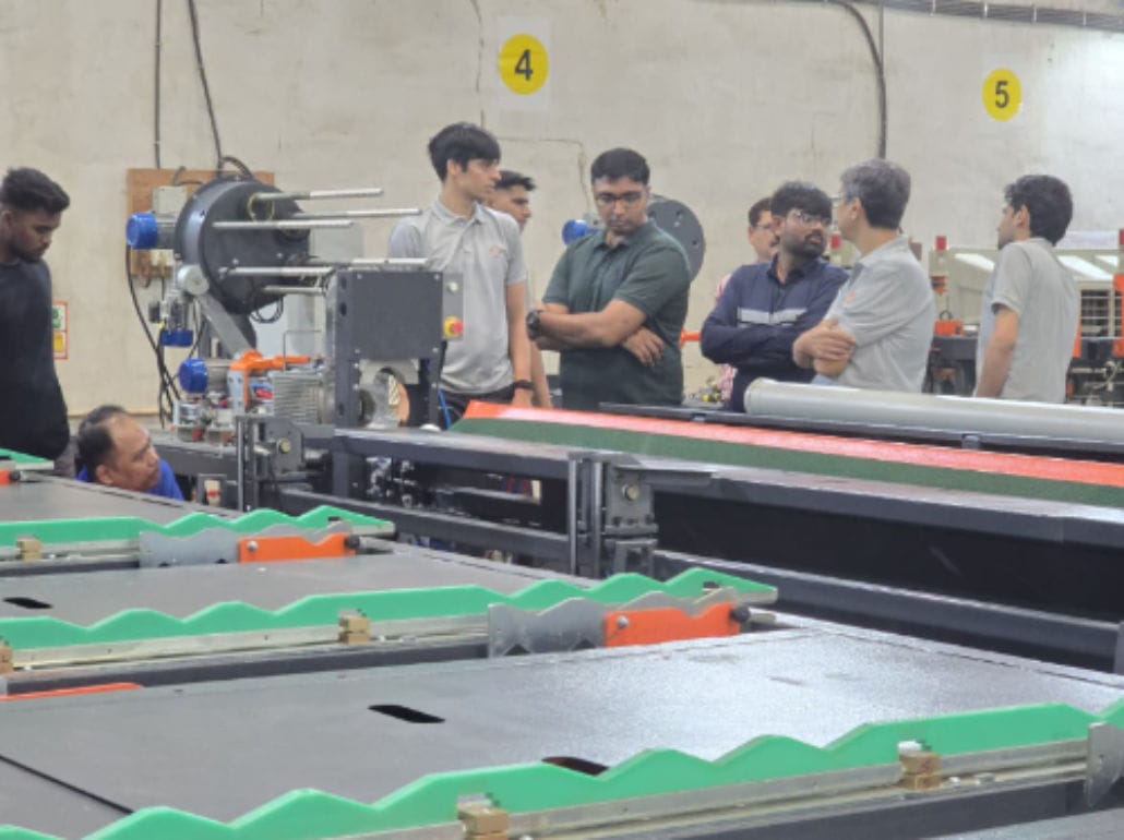 Group of workers inspecting industrial machinery.
