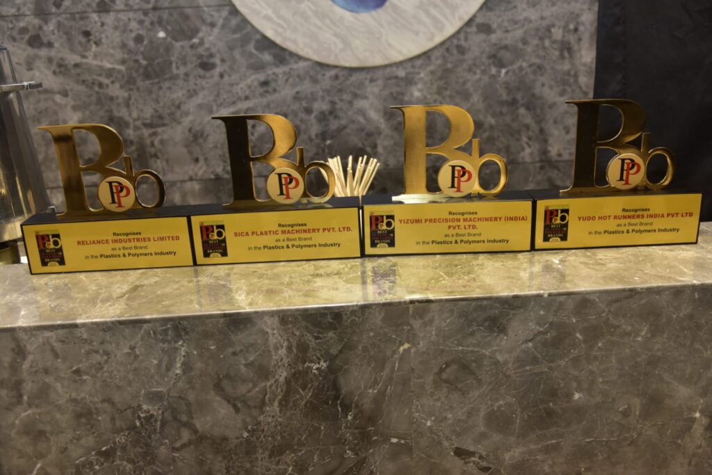 Four gold Best Brand awards displayed on marble counter