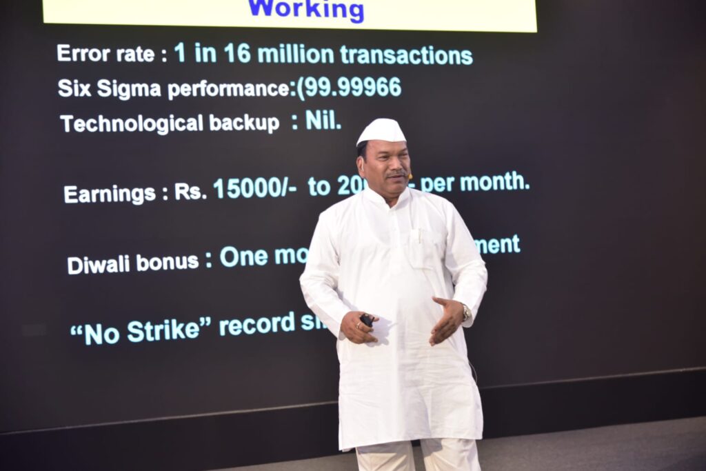 Man presents employment statistics beside projected slide