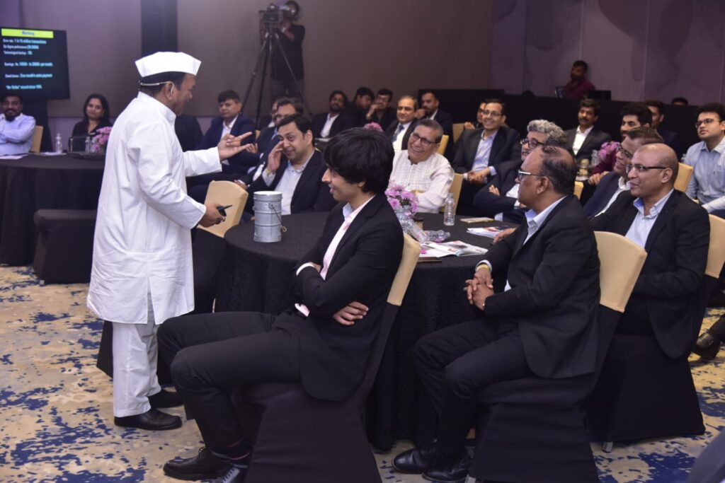 Chef speaks to suited attendees at a conference