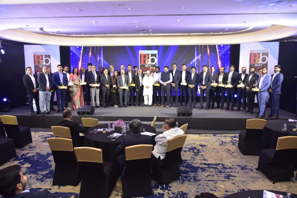 Award recipients pose onstage at Polymers industry ceremony