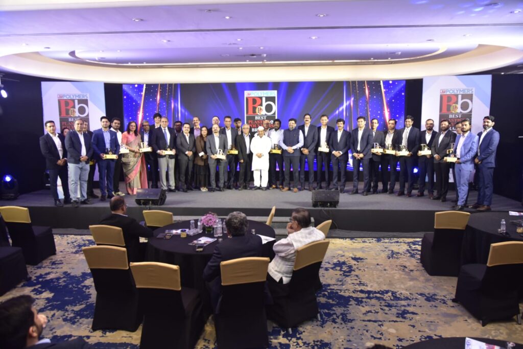 Award recipients pose onstage at polymers industry ceremony