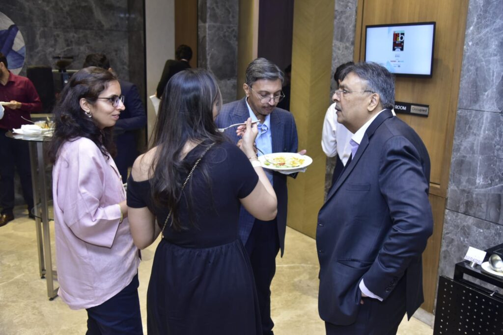 Guests converse during an indoor networking reception