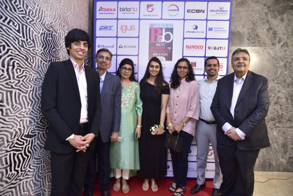 Seven attendees pose at Best Plastics and Polymers Awards backdrop.