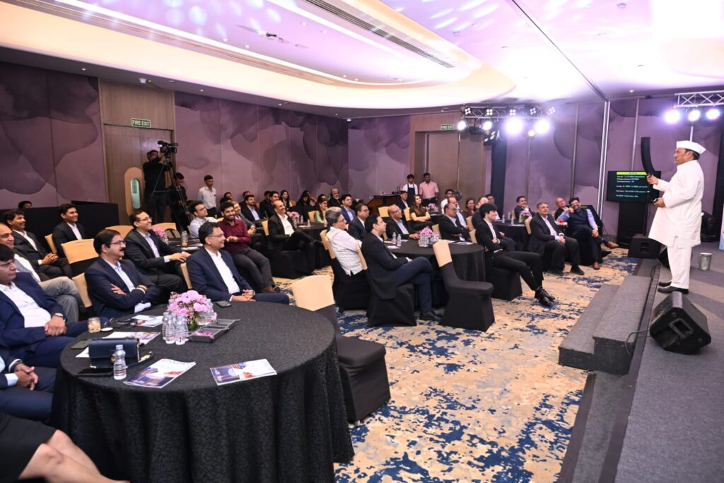 Speaker addresses seated attendees at a business event
