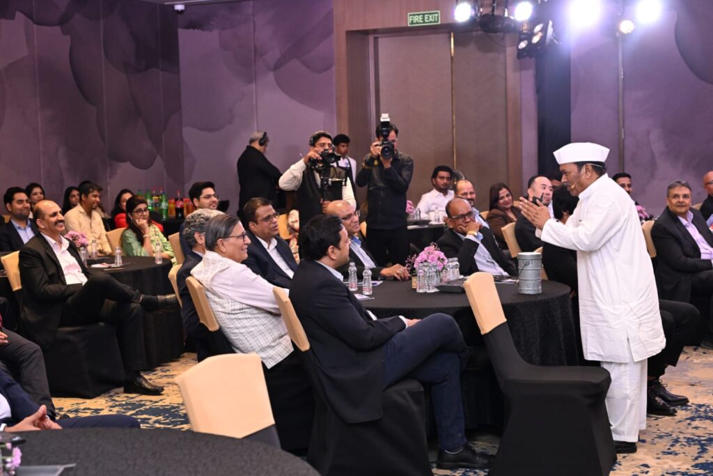 Chef addresses seated guests at a formal banquet event.