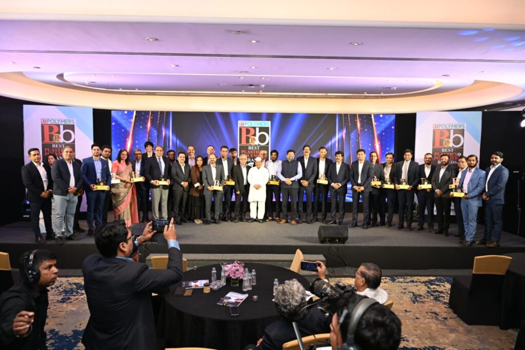 Award recipients pose onstage at polymers industry ceremony