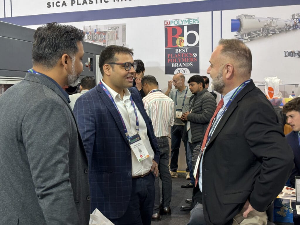 Business professionals networking at plastics industry trade show