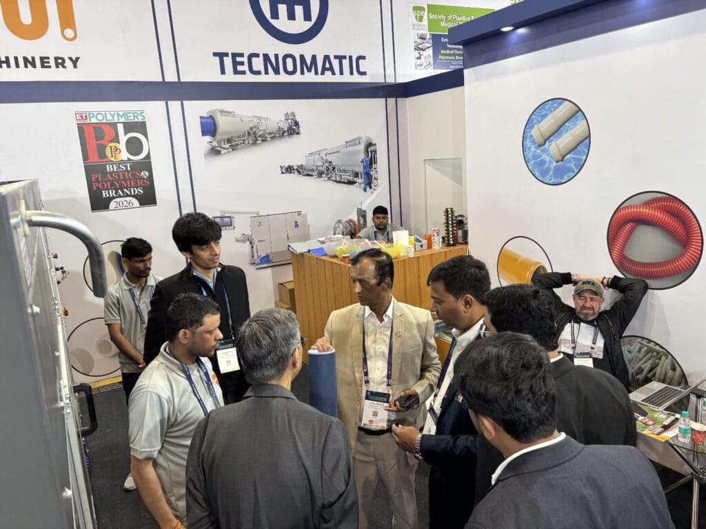 Business professionals discussing machinery at trade show booth