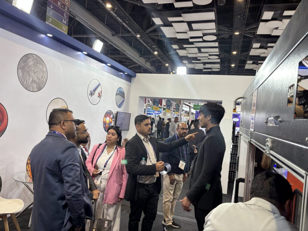 Professionals discussing industrial equipment at trade show booth