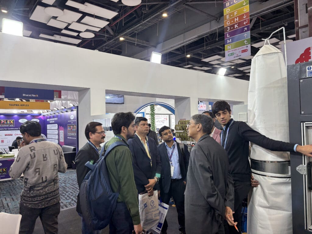 Business professionals discussing equipment at trade show booth