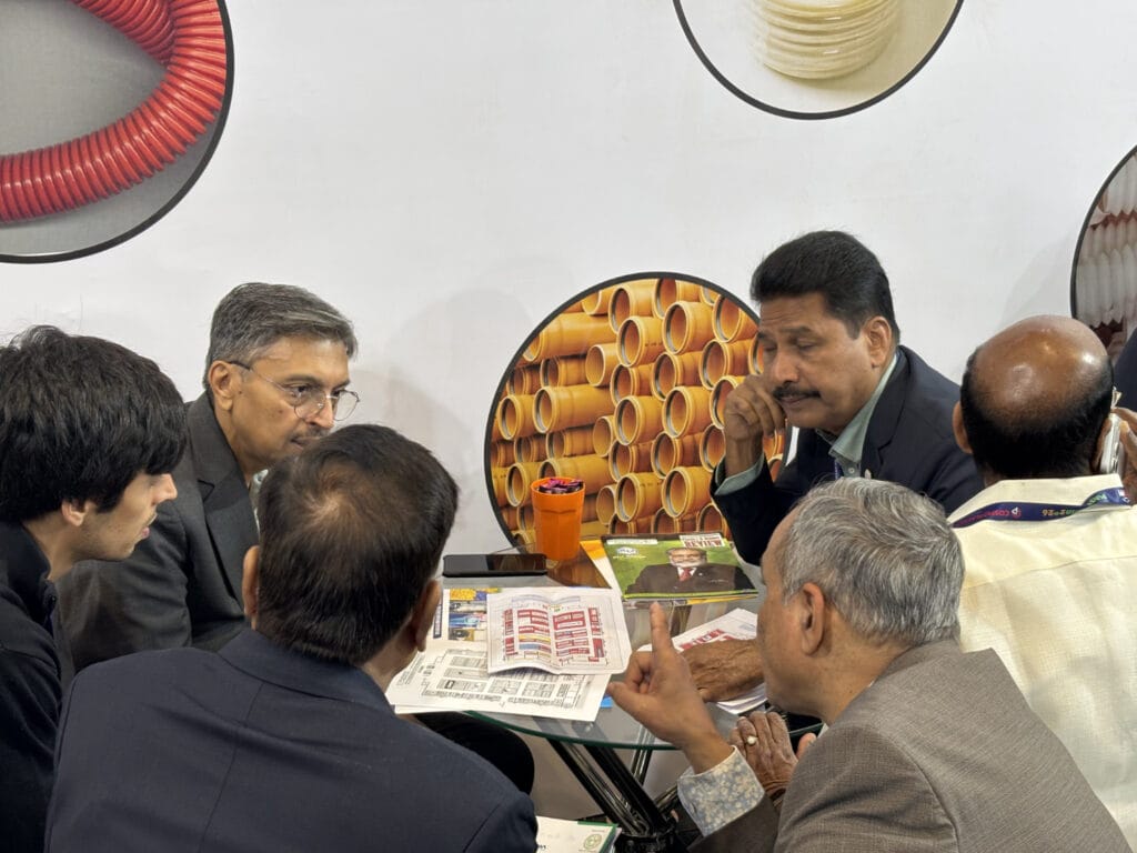 Business professionals discussing documents at trade show booth