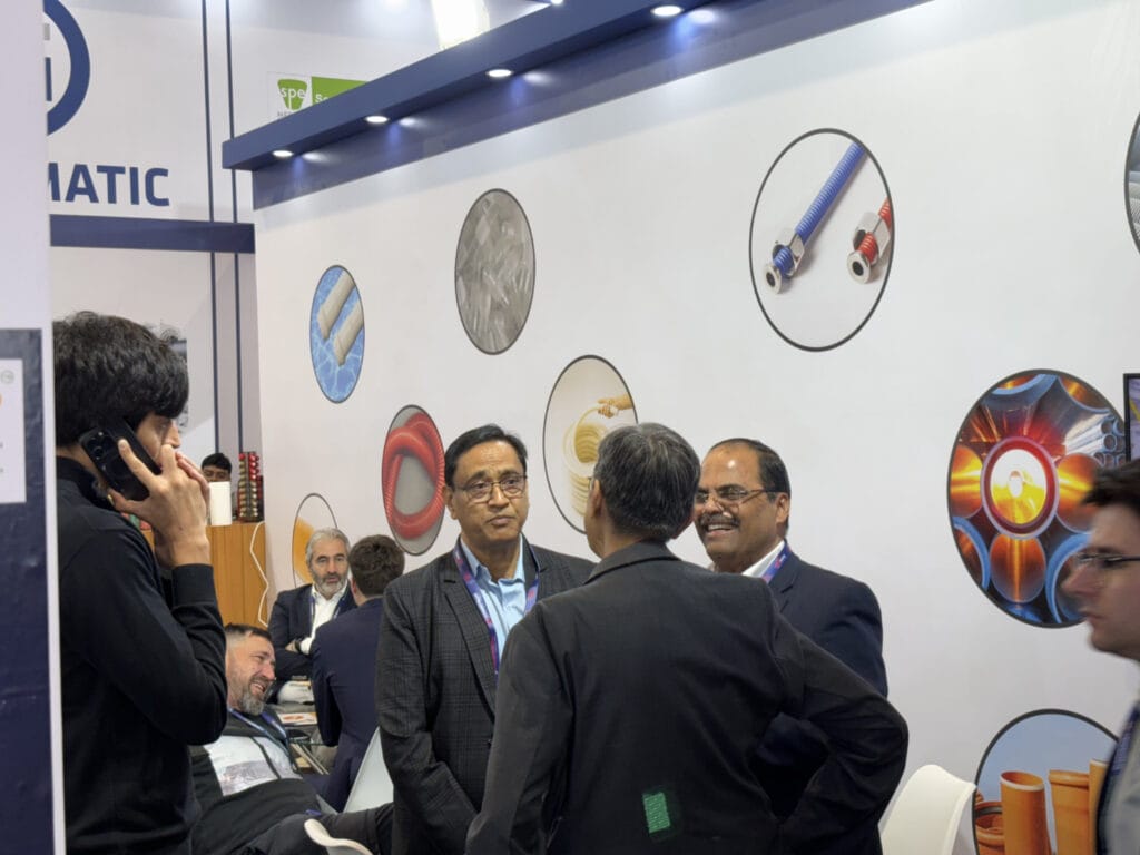 Business professionals networking at industrial trade show booth