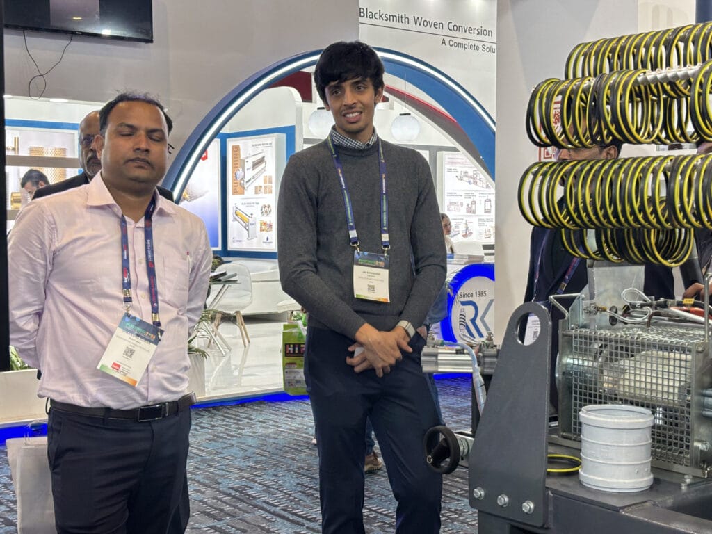 Two men at industrial trade show booth