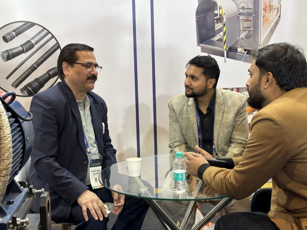 Three businessmen discussing at trade show booth