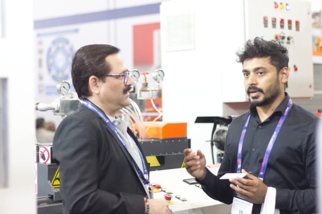 Two professionals discussing machinery at industrial expo