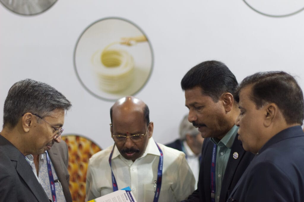 Businessmen reviewing brochure at trade show booth