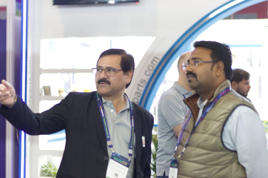 Two men discussing at trade show booth