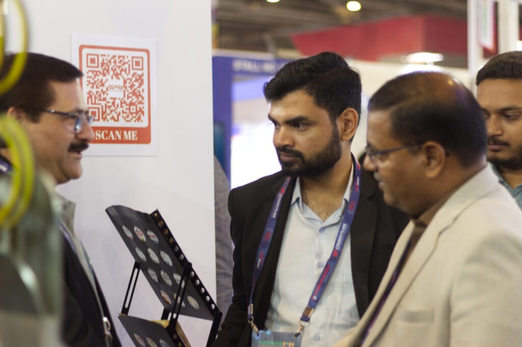 Business professionals discussing at trade show booth