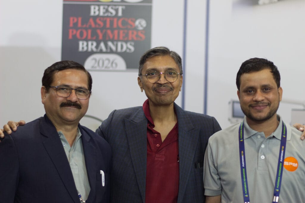 Three men at plastics industry event booth