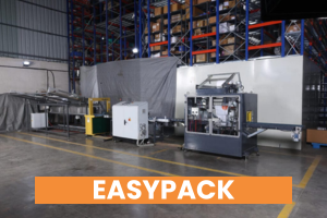 Industrial packaging machine in warehouse facility