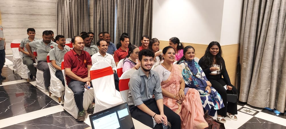 Smiling attendees seated at an indoor event