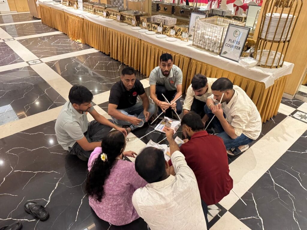Group assembles white rods on banquet hall floor