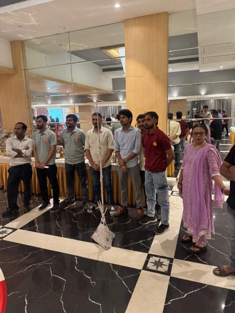 Group of people standing in a mirrored banquet hall
