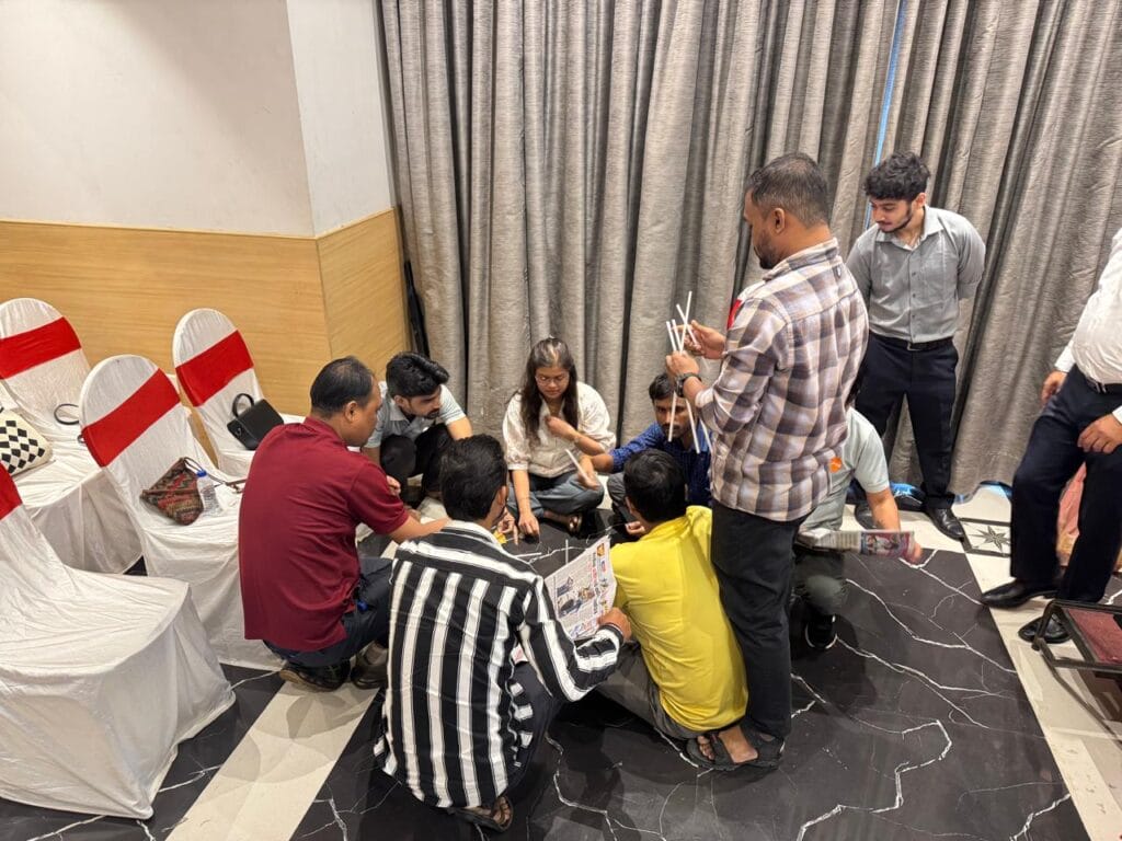 Group builds a structure with straws and newspaper