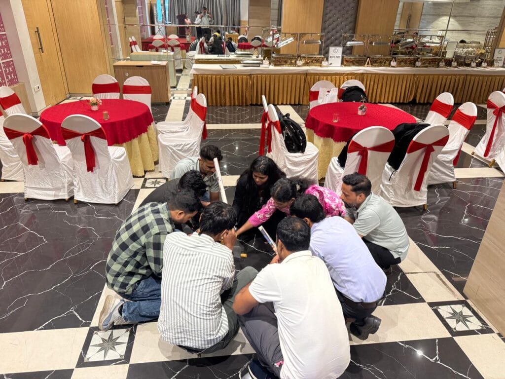 Group gathers on floor in decorated banquet hall