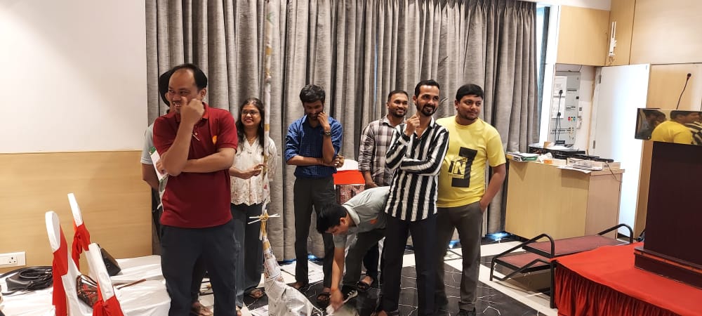 Group of coworkers standing in a decorated indoor event room