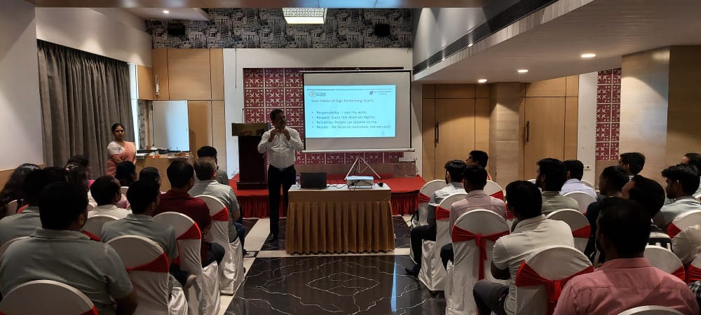 Presenter addresses audience during indoor professional training seminar