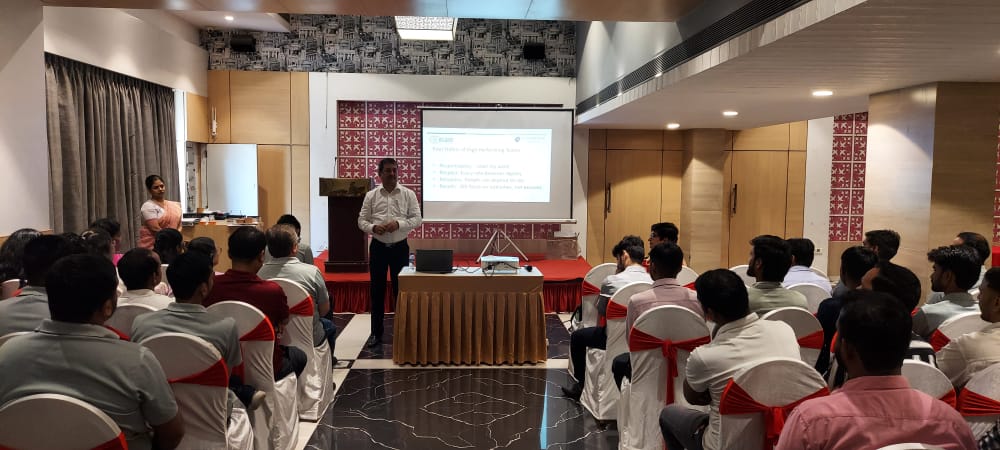 Presenter addresses attendees during an indoor corporate training session