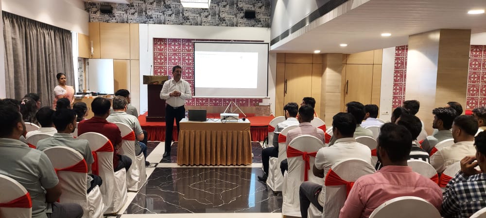 Presenter addresses audience during indoor seminar
