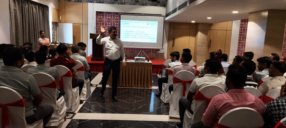 Presenter leading workshop for seated audience in conference room